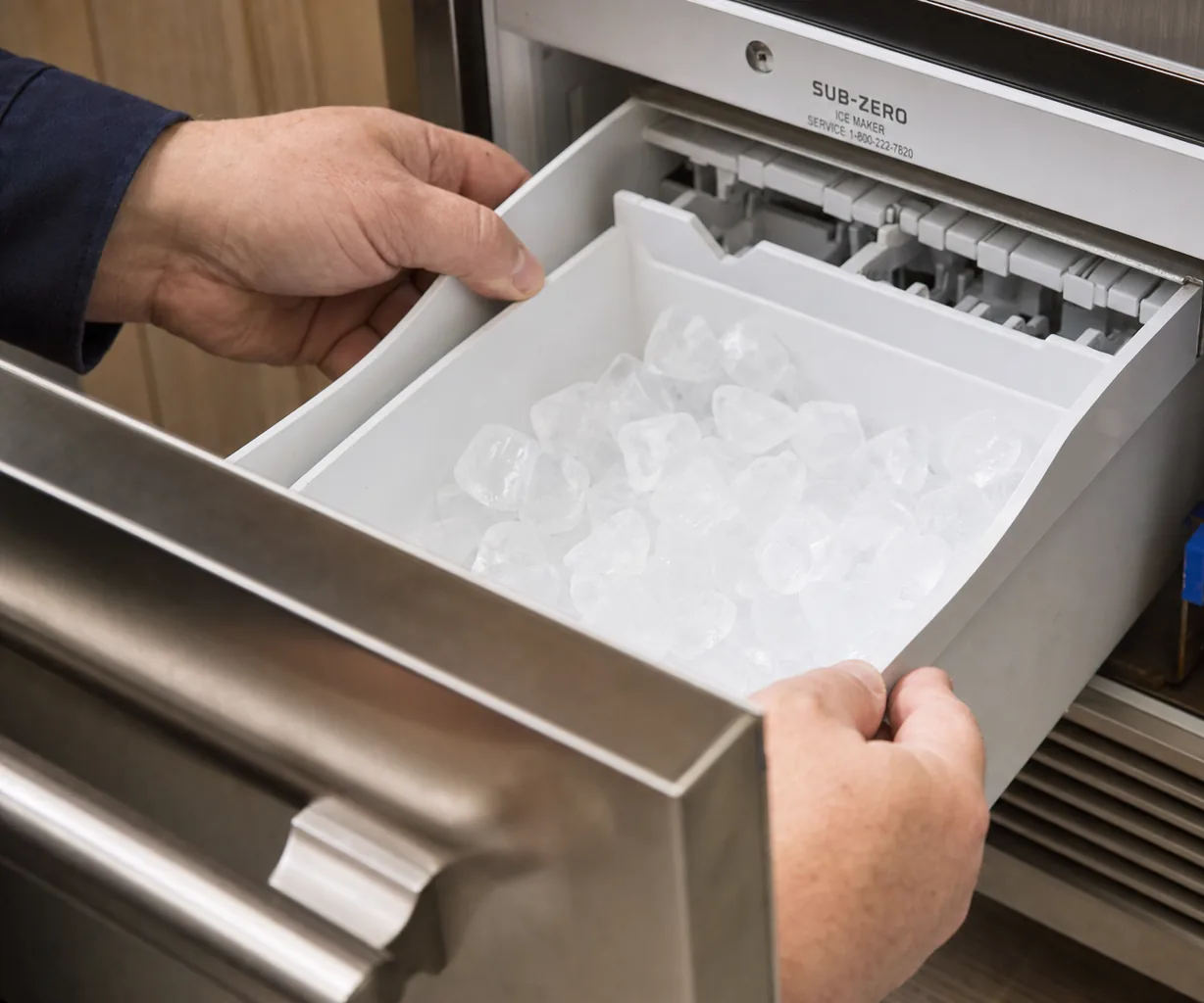 Technician servicing a built-in ice maker in a Mamaroneck kitchen